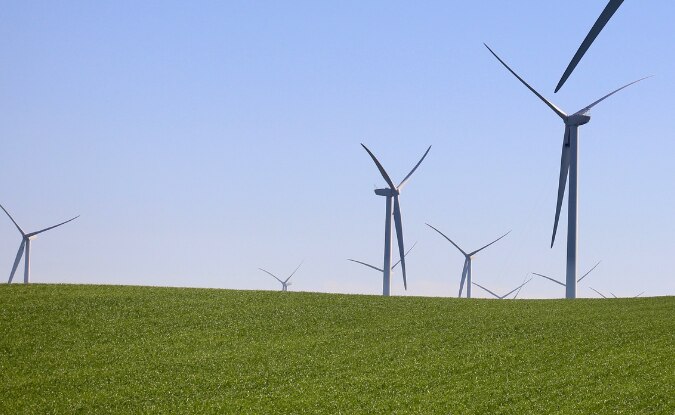 Windmills scattered across field